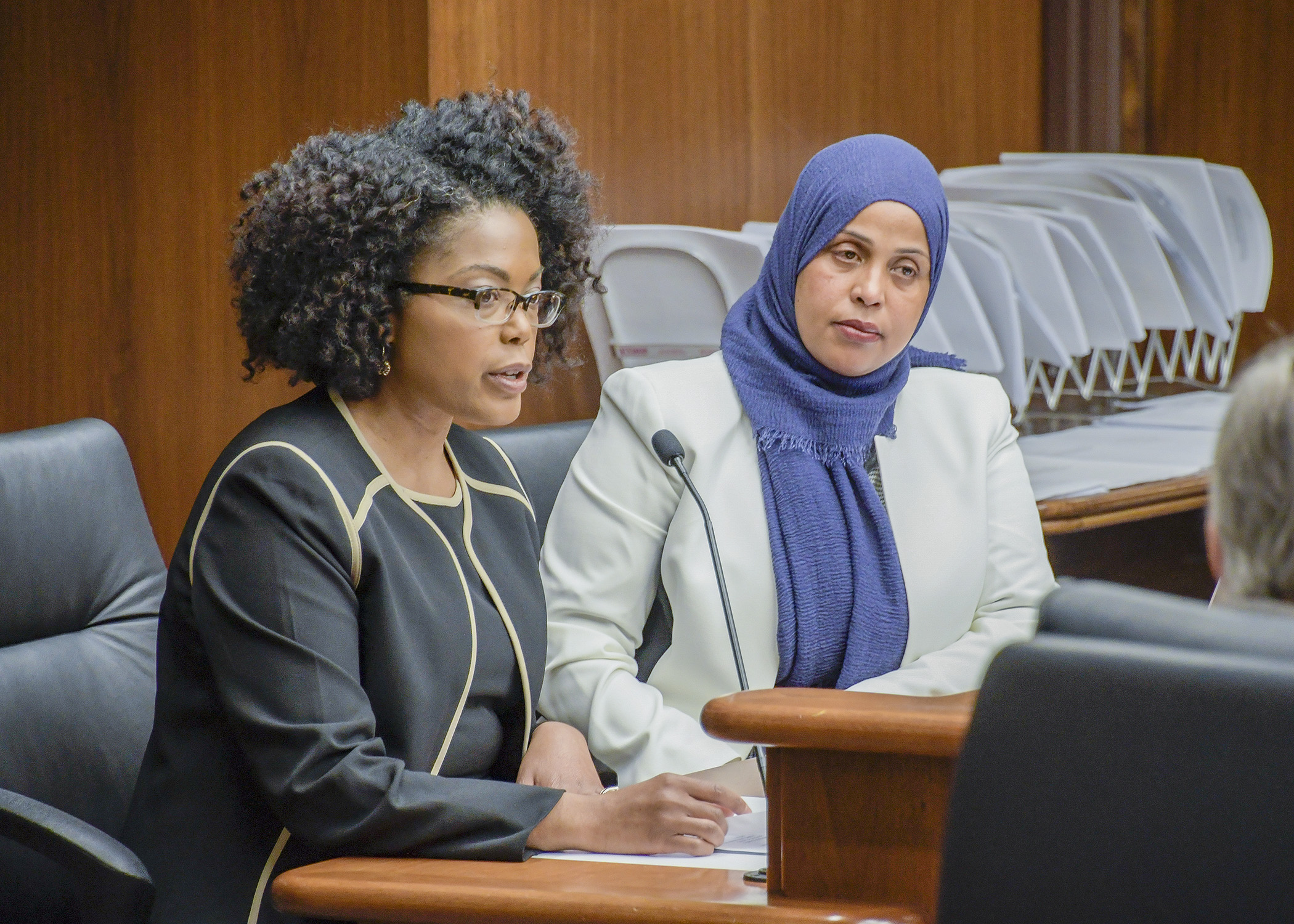 Acooa Ellis, VP for the Greater Twin Cities United Way, testifies before the House Housing Finance and Policy Division March 4 in support of a bill sponsored by Rep. Hodan Hassan, right. Photo by Andrew VonBank